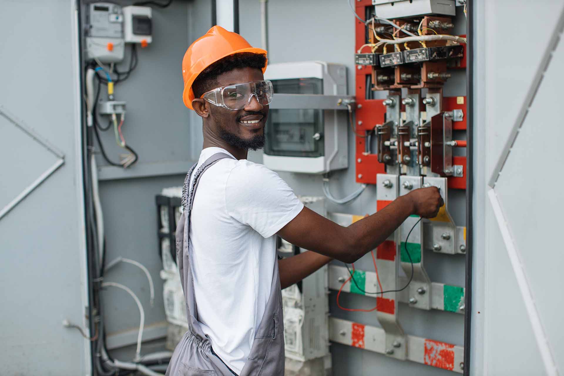 A male technician examining a switchgear.