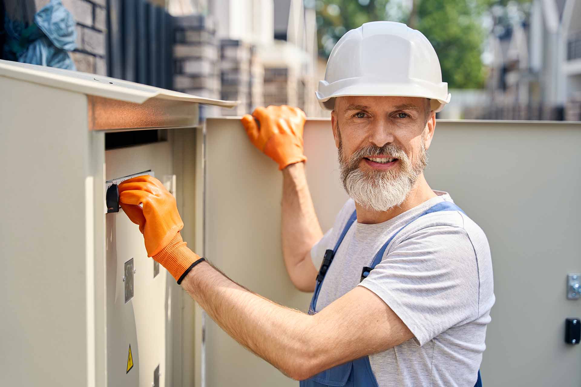 A worker is checking the electric switchboard.