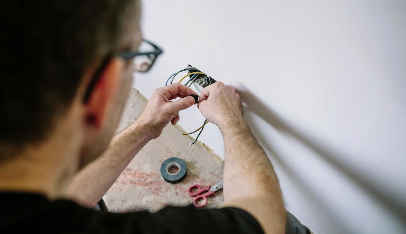 Man working with wires in a home.