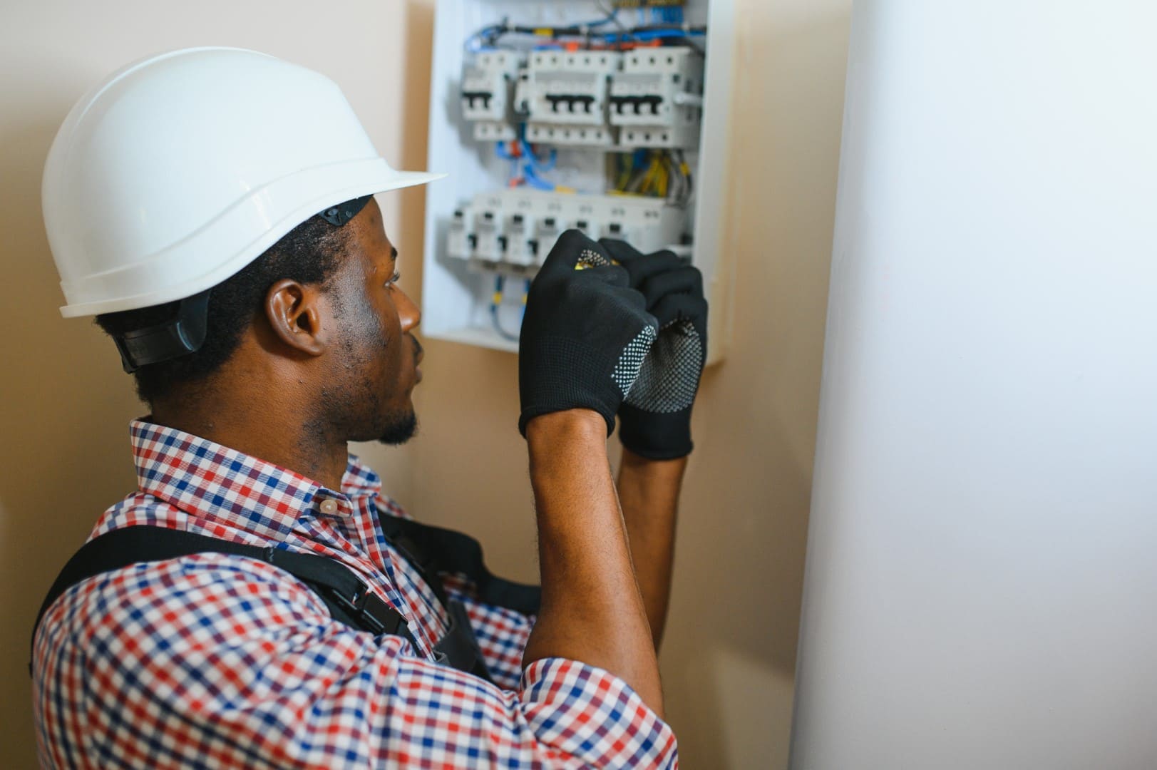 A male electrician fixing the electricity switchboard