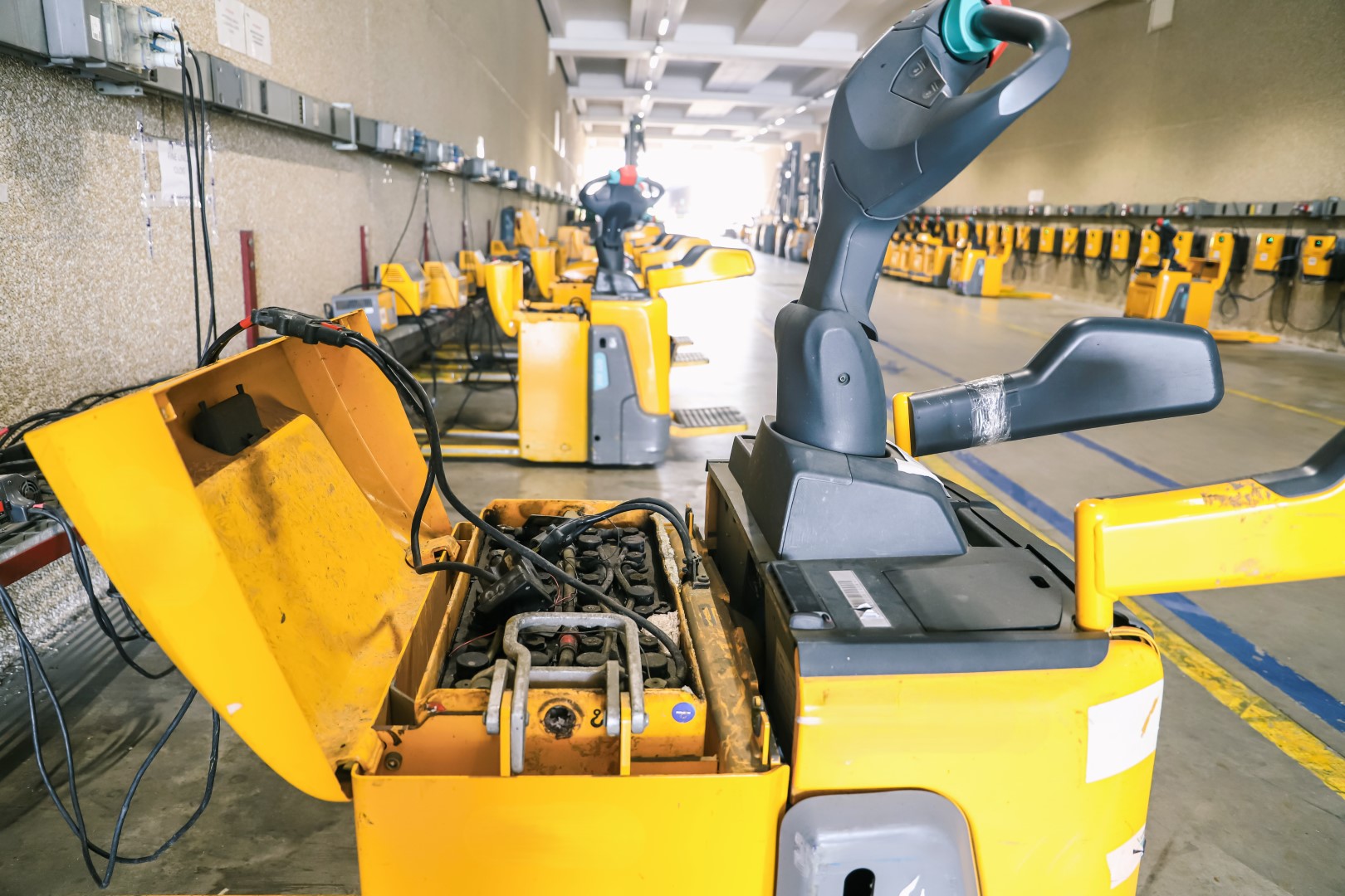 A yellow forklift battery in a garage.